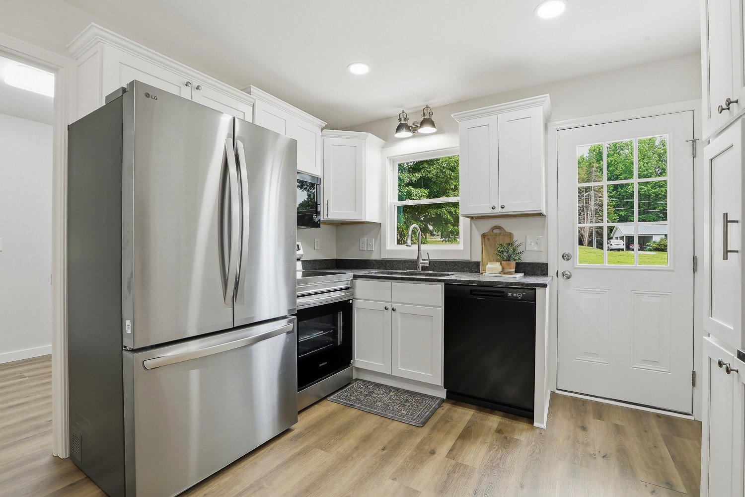 Updated kitchen with custom cabinetry and granite counters