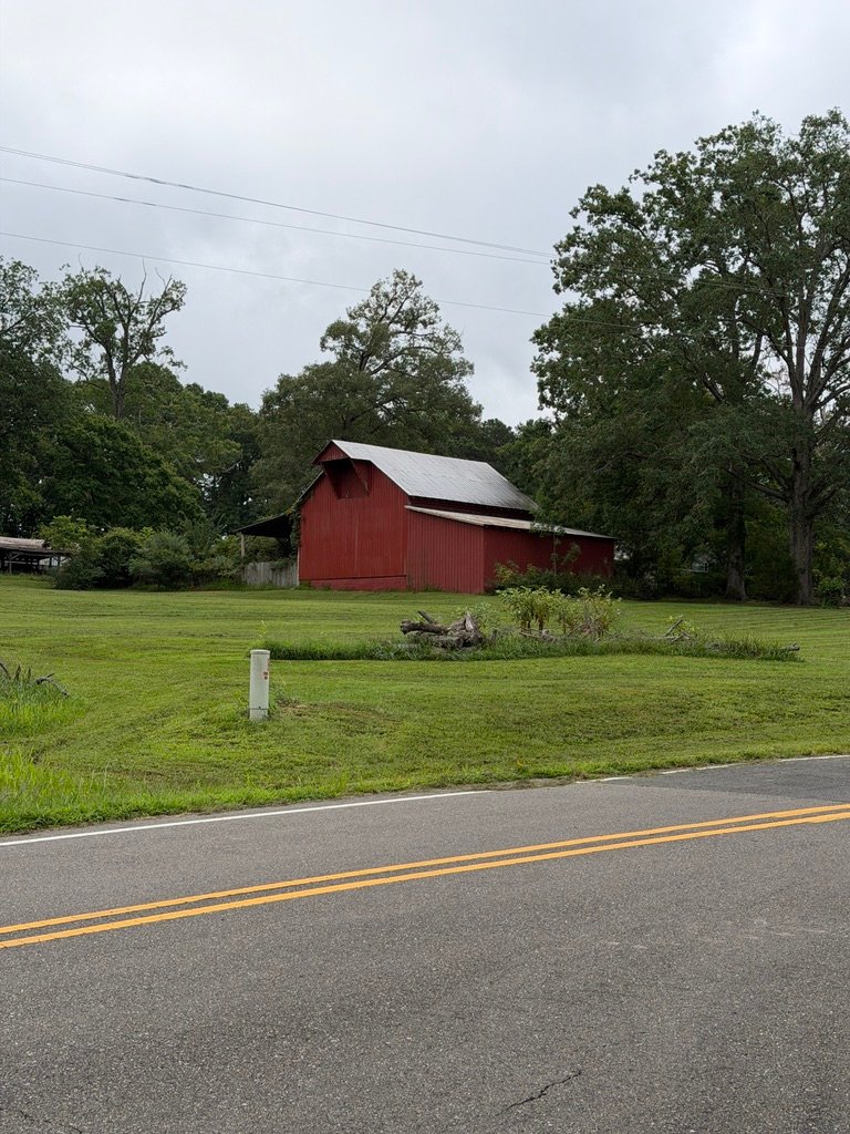 Red barn and open lawn in the Bahama and Rougemont countryside